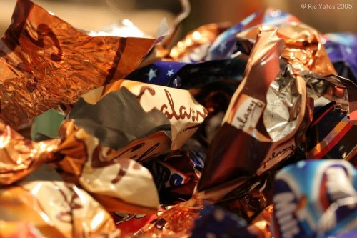 Crew wearing high-visibility PPE loading a skip